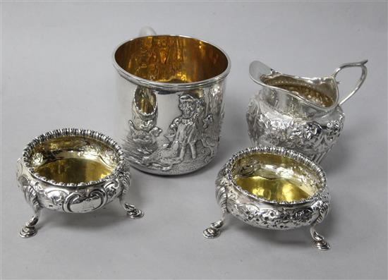 A silver mug, a pair of Victorian silver bun salts and a silver cream jug.